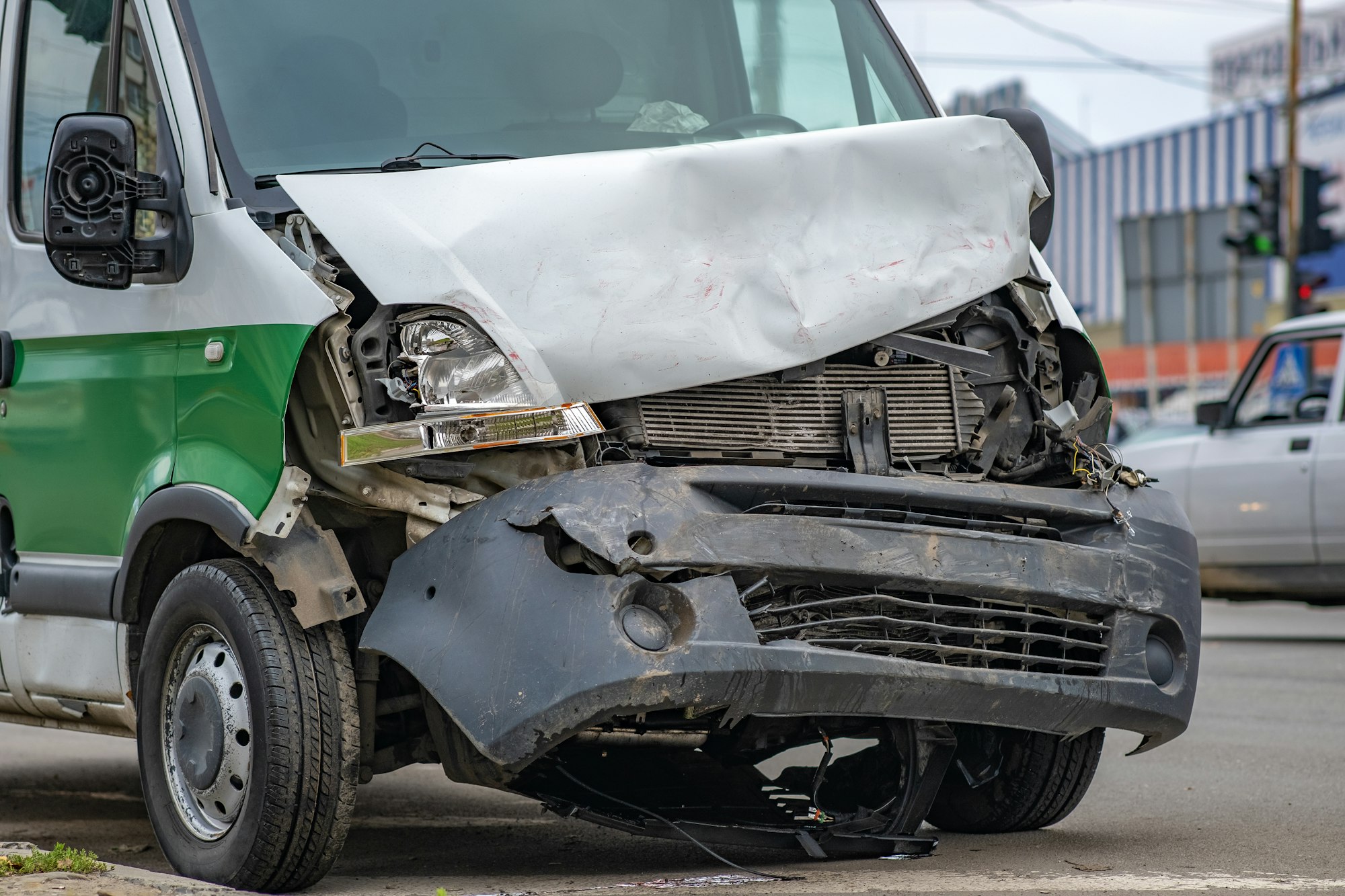 Heavily damaged car after car crash accident on a city street.